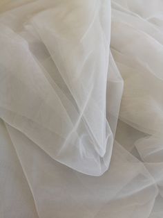 Specification: Colour: Ivory/White/Navy blue/Light gray/Dark gray/Light champagne/Champagne/Dark champagne/Dark pink/Royal blue Composition : Polyester Length : Sell per meter Width : 150 cm / 59 inches Price is per running meter, i.e for the purchase of one unit you will receive 1meter x 1.5 meter tulle. The width is fixed. If you buy 2 we will send you 2 meters X 1.5 meters. This is a superfine high end tulle，It is very delicate and feels super soft. It's perfect for veils and very soft weddin Elegant Cream Sheer Tulle Fabric, Sheer Cream Tulle Fabric, Cream Embroidered Tulle Fabric, Diy Veil, Soft Wedding Dresses, A Day In Paris, Dresses Tulle, Illusion Tulle, Fabric Diy