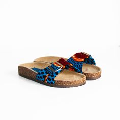 Wax slides / Blue disc wax / Women's shoes / Buckled slides / Blue sandals / Wax print shoes / African fabric This pair of buckled sandals is decorated with a wax disc print with a blue, orange and brown pattern. Sole height: 1.5 cm Straps: faux leather and wax fabric Wax color: blue, orange, brown Insole: faux leather Outsole: faux leather NON-EXCHANGEABLE AND NON-REFUNDABLE ITEM Blue Fabric Open Toe Sandals, Blue Adjustable Slides For Vacation, Blue Sandals With Cork-bed Midsoles For The Beach, Blue Fabric Sandals With Round Toe, Blue Fabric Round Toe Sandals, Blue Open Toe Slides With Cork-bed Midsoles, Blue Beach Slippers With Rubber Sole, Casual Blue Fabric Sandals, Blue Disc