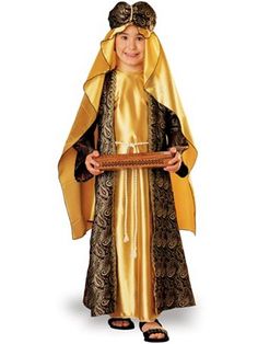 a little boy dressed in a costume holding a plaque with the word jesus on it