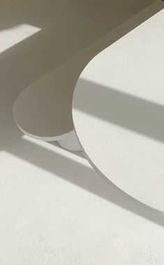 a white table sitting on top of a white floor