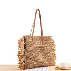 Elena Handbags Large Straw Woven Tote Bag with Tassels and Leather Strap Size: 40cm wide x 38cm tall. (16in x 15in) Designer Style ID: 8220 Large Straw Woven Tote Bag, Summer Bag, Everyday Shoulder Bag, Beach Bag Luxury Beige Jute Beach Bag, Square Shoulder Bag For Beach Season, Square Shoulder Bag For Beach Season Shopping, Trendy Shoulder Bag With Tassels, Rectangular Hobo Bag For Beach Travel, Vacation Brown Shoulder Bag With Long Handle, Trendy Bags With Tassels For Daily Use, Trendy Everyday Bag With Tassels, Brown Long Handle Shoulder Bag For Vacation