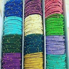 there are many different colors of wire in the box on the table and one is yellow, green, blue, pink, orange