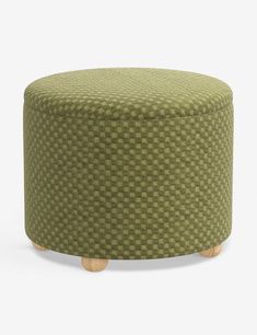 a round ottoman with wooden legs and a green checkered upholstered fabric cover