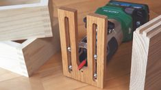 a couple of wood blocks sitting on top of a wooden floor next to a camera