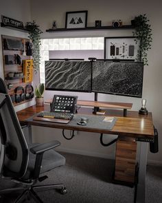 a computer desk with a keyboard, mouse and monitor sitting on top of it in front of a window