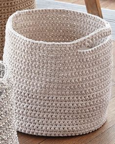 three woven baskets sitting on top of a wooden floor