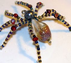 a spider made out of glass beads on a table