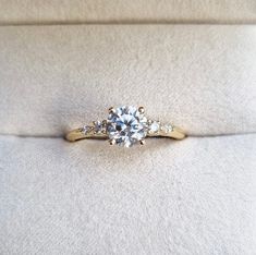 a diamond ring sitting on top of a white cloth