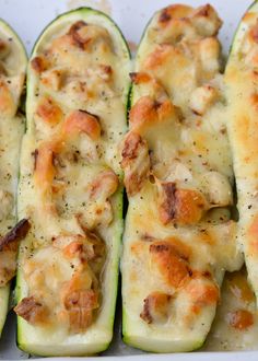 zucchini stuffed with chicken and cheese in a white dish