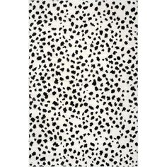 a black and white rug with spots on the top, in front of a white background