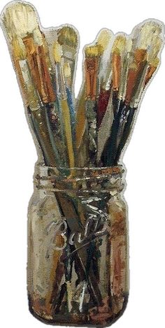 a jar filled with lots of paint brushes