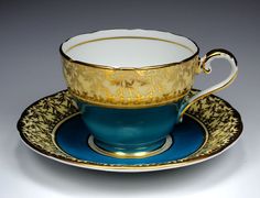 a blue and gold tea cup with saucer