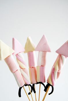 some pink and white candy sticks with black handles