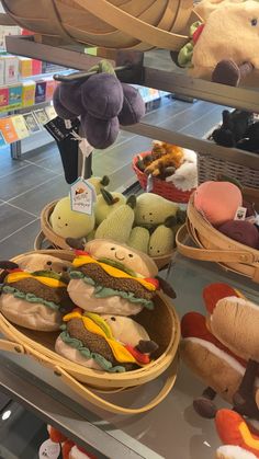 several stuffed animals are on display in baskets