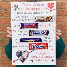 a person holding up a sign with candy on it