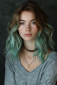 Smoky grey with pastel mint ends offers a modern, subdued look, combining cool tones for a sophisticated and contemporary appearance. Low Matienence Haircut Long Hair, Grey Green Hair, Green Hair Girl, Mint Green Hair, Mint Hair, Blonde Roots, Pastel Mint, Ombre Hair Color, Tone Hair