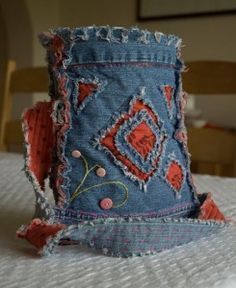 an old pair of jeans has been turned into a purse with holes in the fabric