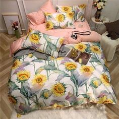 a bed with sunflowers and pink sheets on it