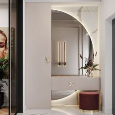 the interior of a modern bathroom with white walls and marble flooring, along with an oval mirror on the wall