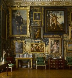 an ornate room with paintings on the wall