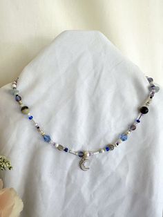 16.5 in. beaded necklace with moon pendant. Diy Moon Necklace, Light Blue Bead Necklace Mushroom, Moon Beaded Necklace, Bohemian Necklaces With Moon Charm And Round Beads, Celestial Blue Beaded Necklaces, Blue Jewelry With Moon Charm And Round Beads, Celestial Jewelry With Moon Charm And Round Beads, Moon Charm Necklace With Round Beads For Gifts, Moon Charm Necklace With Round Beads As Gift