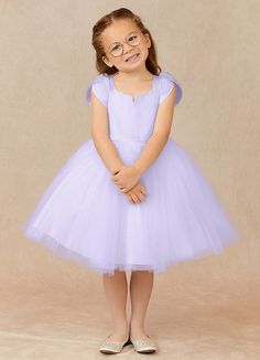 Let your flower girl be the whimsical princess she is while wearing our matte satin and tulle dress, Malinda. Her square neckline is framed with delicate pleated tulip sleeves that offer a wide range of motion. Her waist has a thin belt that sits atop an airy keen length tulle skirt. Lilac Ball Gown, Lilac Flower Girl Dresses, Grey Flower Girl Dress, Gray Flower Girl, Whimsical Princess, Grey And Coral, Tulle Flower Girl, Tulip Sleeve, Flower Girl Dresses Tulle