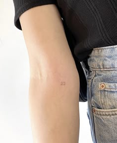 a person with a small tattoo on their arm