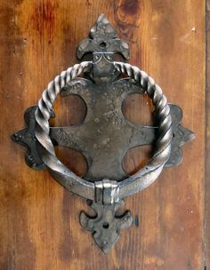 an old metal door handle on a wooden door