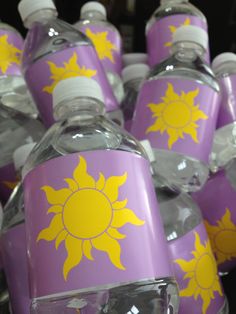 purple and yellow water bottles sitting on top of each other