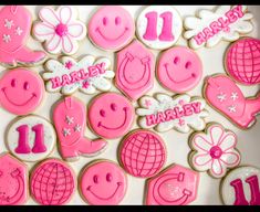 decorated cookies with pink icing and happy birthday messages on them are arranged in the shape of smiley faces