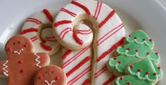 a plate with christmas cookies and decorated cookies on it