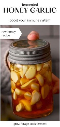 a person holding a jar filled with honey garlic