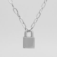 The latest addition to our 24/7 Day Collar range. A stunning mid sized silver stainless steel paperclip chain adorned with a full stainless steel padlock making this necklace the ultimate must have for daily wear of your collar. 8mm Solid Stainless Steel Paperclip Chain Full 316L Stainless Steel Padlock Standard Hex (Allen) Key Supplied Comes in Gift Box as pictured at no extra cost Suitable for 24/7 Wear Hypoallergenic Full Waterproof Design Hand Made in the UK The padlock is non mechanical and Layering Earrings, O Ring Choker, Gothic Bracelet, Word Necklace, Gothic Pendant, Day Collar, Bracelet Box