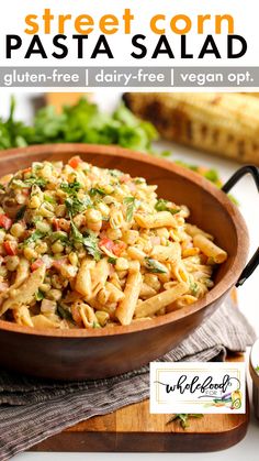 pasta salad in a wooden bowl on top of a cutting board with text overlay