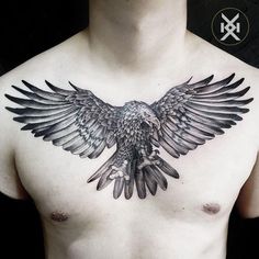 a man's chest with an eagle tattoo on it