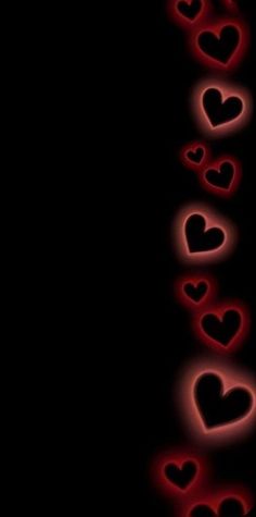 the word love is written in red and black letters on a dark background with hearts