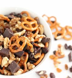 a white bowl filled with chocolate trail mix