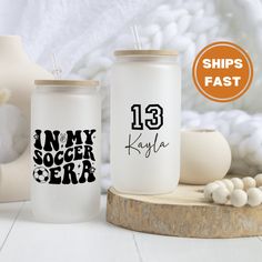 two personalized tumblers with the names of soccer players and numbers on them, one for each team