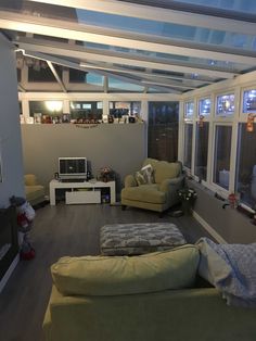 a living room filled with furniture and lots of windows