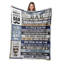 a woman holding up a blanket with words on it