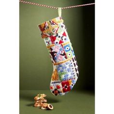 a christmas stocking hanging from a clothes line next to a small gingerbread cookie