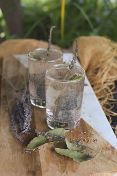 two glasses filled with water and lavender sprigs