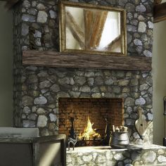 a stone fireplace with a mirror above it