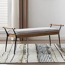 a bench sitting on top of a rug next to a window