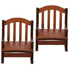 two wooden chairs sitting next to each other