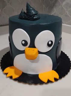 a cake with a penguin face on it