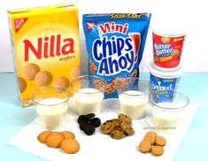 cookies, milk, and other snacks are sitting on a table next to each other