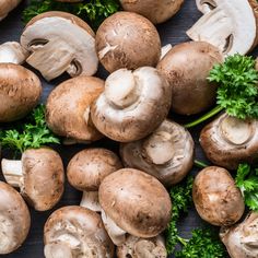 mushrooms and parsley on a wooden surface