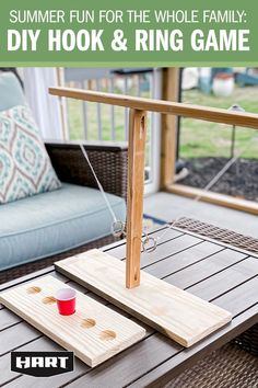 a diy hook and ring game sitting on top of a wooden table next to a couch