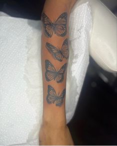 a woman's arm with four butterflies on it and the words, i love you